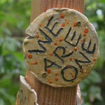 A stone with the text "we are one"